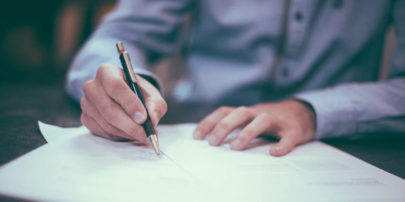 Business owner signing LLC formation documents