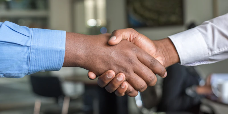 Business partners shaking hands on ownership change