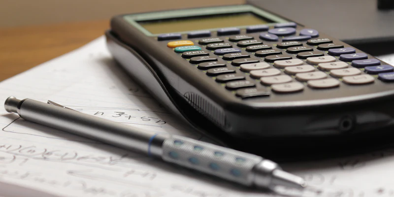 Calculator and pen on tax documents